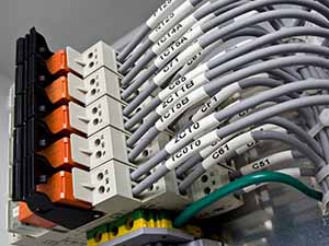 A group of networking cables organized with wire labels for easy identification.