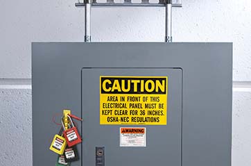 An electrical panel with multiple lockout padlocks attached to it. The panel includes a prominent yellow caution sign and an arc flash warning label to alert workers to potential hazards.