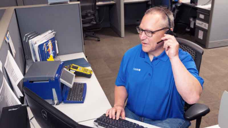 A Brady technical support rep on a call with a customer.